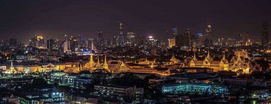 Bangkok skyline at night with Grand Palace in the foreground — a top digital nomad hub in Thailand